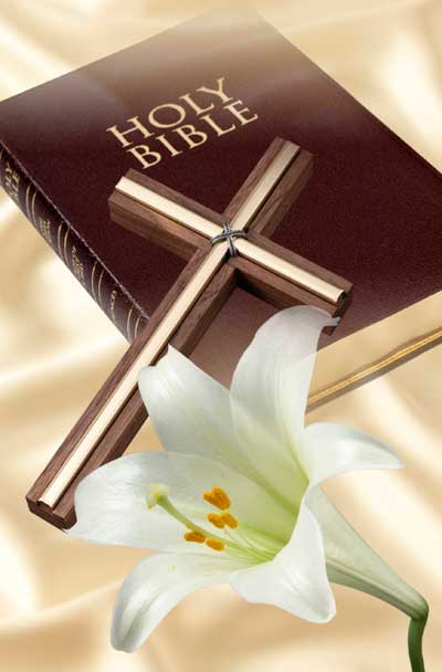 Bible with Cross and Easter Lily laying on top.